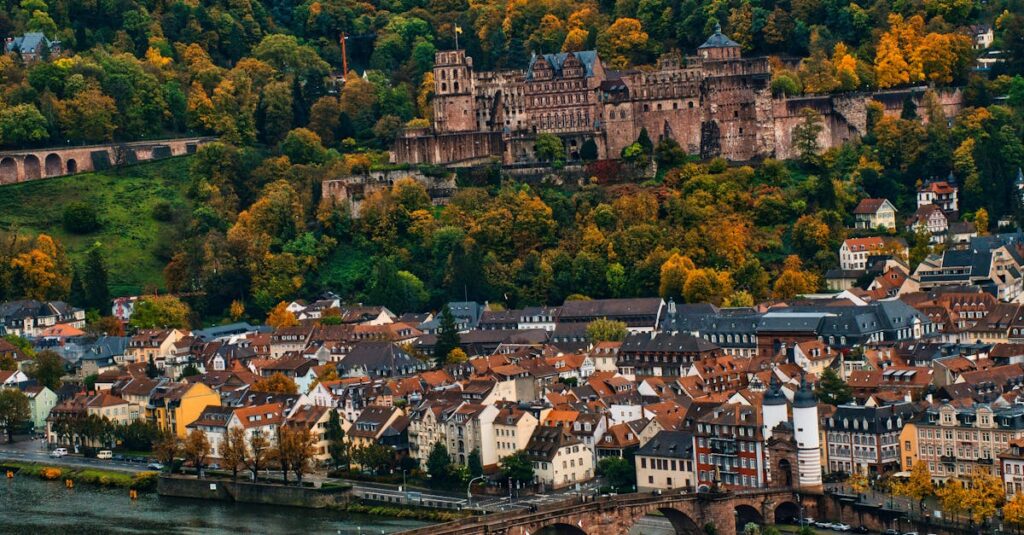 Captivating view of Heidelberg Castle and the Old Bridge over the Neckar River in autumn.